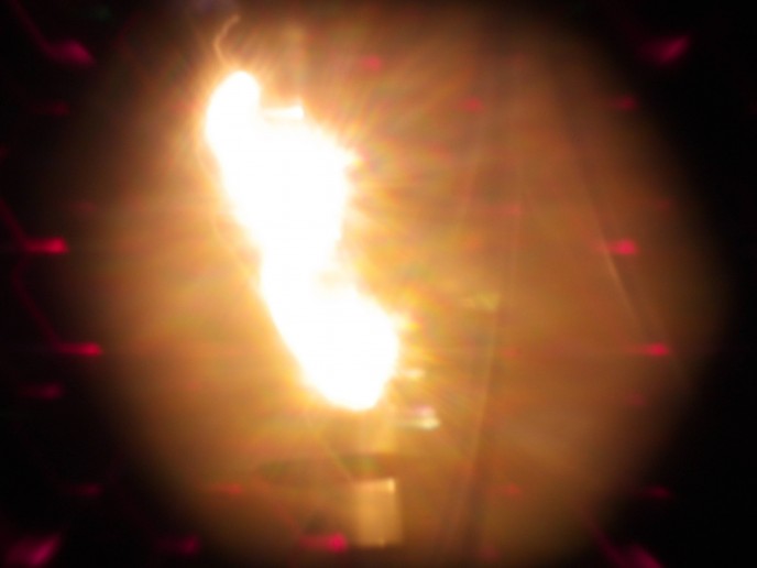 Colored light shoots out of a light bulb