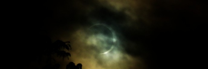 clouds cover the sun during a solar eclipse